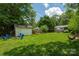 Large backyard featuring a fire pit, hammock, and a storage building at 3531 Enfield Rd, Charlotte, NC 28205