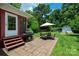 Spacious backyard with brick patio, outdoor seating, a grill, a lawn, landscaping, and a storage shed at 3531 Enfield Rd, Charlotte, NC 28205