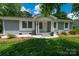 Charming single-story home featuring a well-manicured lawn, painted brick, and a welcoming front porch at 3531 Enfield Rd, Charlotte, NC 28205