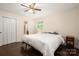 Bedroom with hardwood floors, closet, and a window providing natural light and an ensuite bathroom at 3531 Enfield Rd, Charlotte, NC 28205