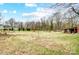 Expansive backyard featuring a storage shed and bordered by mature trees, offering a private outdoor space at 354 Baptist Church Rd, Gold Hill, NC 28071