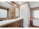 Well-lit bathroom with double sinks, wood cabinetry and convenient access to bathtub and shower at 354 Baptist Church Rd, Gold Hill, NC 28071