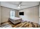 Bedroom with wood-look floors and mounted television for entertainment at 354 Baptist Church Rd, Gold Hill, NC 28071