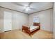 Cozy bedroom features wood-look floors, a ceiling fan, and a sunlit window at 354 Baptist Church Rd, Gold Hill, NC 28071