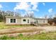 Single-story home featuring neutral siding, white windows, and a ramp to a small front porch at 354 Baptist Church Rd, Gold Hill, NC 28071