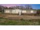 Tan, single-story home with symmetrical windows, white trim, and a small porch at 354 Baptist Church Rd, Gold Hill, NC 28071