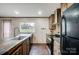 Modern kitchen featuring an island sink, stainless steel appliances, and custom wooden floors at 354 Baptist Church Rd, Gold Hill, NC 28071