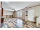 Open living room with unique two-tone floors, ceiling fan, and lots of natural light at 354 Baptist Church Rd, Gold Hill, NC 28071