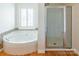 Bathroom with garden tub, shower, and hardwood floors at 3624 Ramsey Rd, Sharon, SC 29742