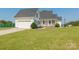 White two-car garage, front porch, and well-maintained lawn at 3624 Ramsey Rd, Sharon, SC 29742