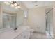 Bathroom featuring a single sink vanity, toilet, and tiled shower and tub combo, with a unique window at 4316 Mourning Dove Dr, Matthews, NC 28104