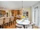 Bright breakfast nook with hardwood floors, chandelier, and access to the kitchen and backyard at 4316 Mourning Dove Dr, Matthews, NC 28104