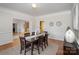 Elegant dining room features a wooden table, classic wainscoting, and neutral decor for a welcoming ambiance at 4316 Mourning Dove Dr, Matthews, NC 28104