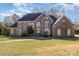 Stately brick home featuring a well-manicured lawn, arched windows, and a classic architectural design at 4316 Mourning Dove Dr, Matthews, NC 28104