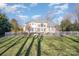 Spacious home exterior featuring a white fence and lush green lawn at 4316 Mourning Dove Dr, Matthews, NC 28104