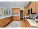 Traditional kitchen featuring wood cabinetry, stainless steel appliances, and a ceiling fan at 4316 Mourning Dove Dr, Matthews, NC 28104