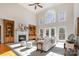 Bright living room boasts a fireplace, built-in cabinets, large windows, and stylish, neutral furniture at 4316 Mourning Dove Dr, Matthews, NC 28104