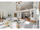 Bright living room with fireplace, neutral furniture, grand staircase, and large windows at 4316 Mourning Dove Dr, Matthews, NC 28104