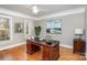 Cozy home office with wooden desk, hardwood floors, natural light, and traditional decor at 4316 Mourning Dove Dr, Matthews, NC 28104