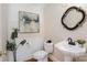 Charming powder room featuring a pedestal sink, decorative mirror, and stylish decor at 4316 Mourning Dove Dr, Matthews, NC 28104