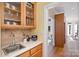 Convenient wet bar with a sink, glass-front cabinets, and a view into the sunroom at 4316 Mourning Dove Dr, Matthews, NC 28104