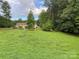 Spacious backyard with large grassy area and mature trees at 475 Cornerstone Dr, Taylorsville, NC 28681