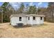 View of back exterior with a door, windows, and HVAC unit at 5483 Paulmo Dr, Charlotte, NC 28216