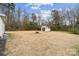 Spacious backyard with a fire pit and storage shed at 5483 Paulmo Dr, Charlotte, NC 28216