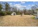 Large backyard features a fire pit area and storage sheds at 5483 Paulmo Dr, Charlotte, NC 28216