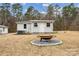 Backyard with a fire pit and storage shed at 5483 Paulmo Dr, Charlotte, NC 28216