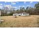 View of house and auxiliary structure in large back yard at 5483 Paulmo Dr, Charlotte, NC 28216