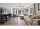 Bright living room featuring a large sectional sofa, wood-look flooring, and TV at 5483 Paulmo Dr, Charlotte, NC 28216