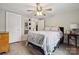 Bright main bedroom with light wood floors, ceiling fan, closet and exterior view at 5483 Paulmo Dr, Charlotte, NC 28216