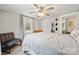 Bright main bedroom featuring a ceiling fan, chair, and a large window that illuminates the gray walls at 5483 Paulmo Dr, Charlotte, NC 28216