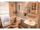 Bathroom with pedestal sink, toilet, and decorative accents at 5711 Falls Ridge Ln, Charlotte, NC 28269