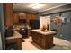 Kitchen features wood cabinets, an island, and black appliances at 5711 Falls Ridge Ln, Charlotte, NC 28269