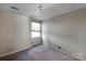 Simple basement bedroom with a window and carpeted floor at 6017 Millbury Ct # 16, Charlotte, NC 28211