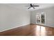 Bright bedroom with hardwood floors, ceiling fan, and large window at 6017 Millbury Ct # 16, Charlotte, NC 28211