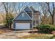 Gray two-story house with attached garage and landscaped yard at 6017 Millbury Ct # 16, Charlotte, NC 28211