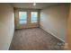 Bright bedroom with two windows and neutral carpet flooring at 624 Cassidy Ct, Clover, SC 29710