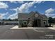 Exterior of the community clubhouse with a pool view, ample parking and well-maintained landscaping at 624 Cassidy Ct, Clover, SC 29710