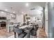 Dining room with open access to the kitchen and Gathering room, modern decor and plenty of natural light at 624 Cassidy Ct, Clover, SC 29710