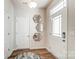 Bright entryway featuring wood-look floors, a modern door, and decorative mirrors that add a stylish touch at 624 Cassidy Ct, Clover, SC 29710