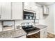 Modern kitchen features gray cabinets, granite counters, tile backsplash, and stainless steel appliances at 624 Cassidy Ct, Clover, SC 29710