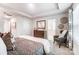 Main bedroom featuring coffered ceiling, ensuite, stylish chair and decor at 624 Cassidy Ct, Clover, SC 29710