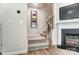 Carpeted staircase with a wooden banister leading to the second floor, adjacent to the fireplace at 624 Cassidy Ct, Clover, SC 29710