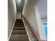 Carpeted stairway with wooden handrail leading to the upper level of the house at 624 Cassidy Ct, Clover, SC 29710