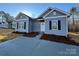 Newly constructed home with gray siding, and a small front yard at 715 Queens Ct, Gastonia, NC 28052