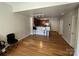 Living room with hardwood floors and a view of the kitchen with breakfast bar at 721 Governor Morrison St, Charlotte, NC 28211