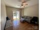 Living room with hardwood floors, gray sofa, and access to a balcony at 721 Governor Morrison St, Charlotte, NC 28211